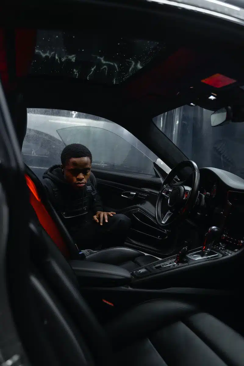 Man in Black Jacket Sitting on Car Seat